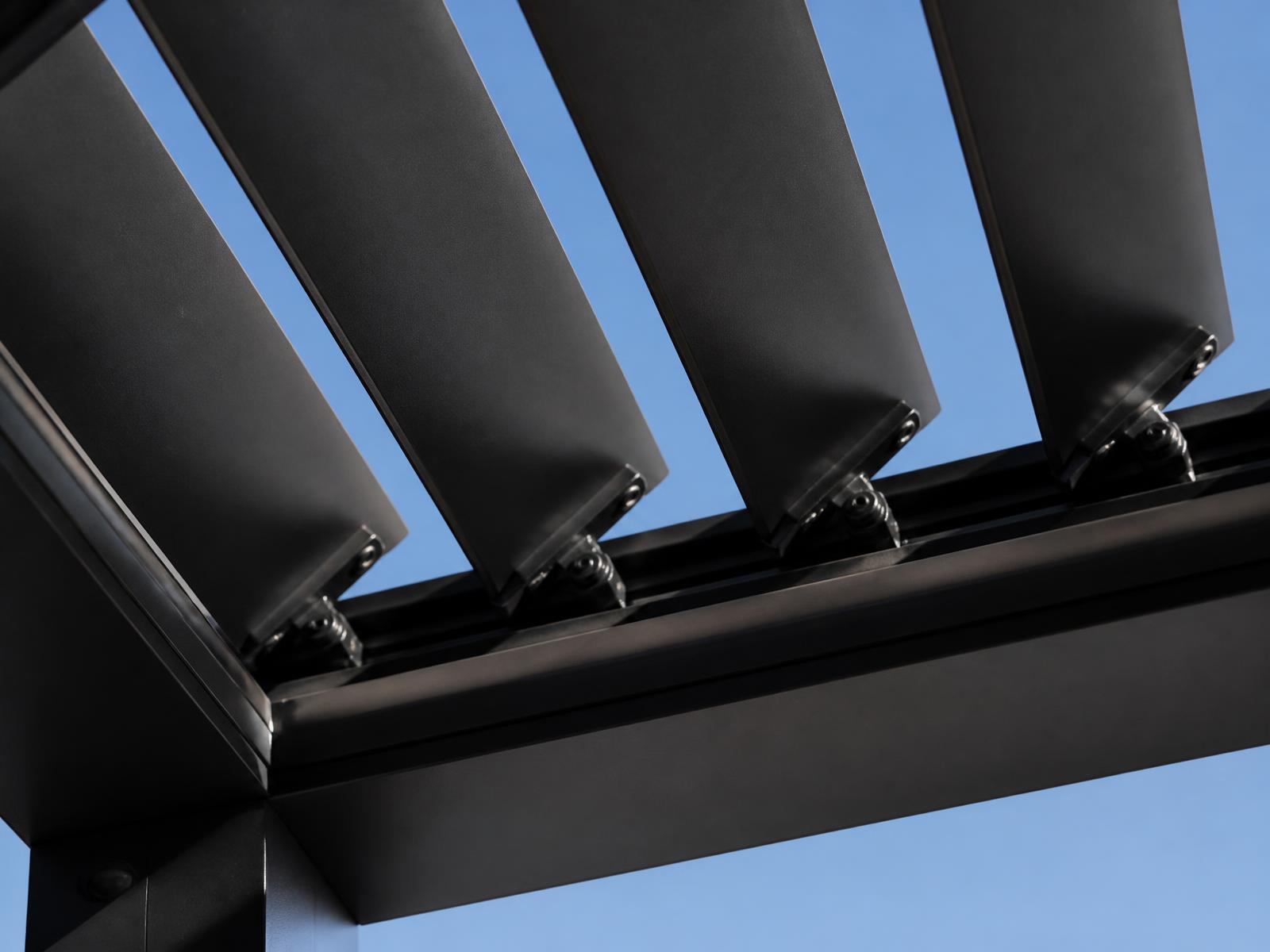 Motorised aluminium louvre blades in the roof plane, rotating open against the sky